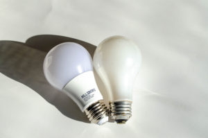 LED and incandescent lightbulb side by side for comparison
