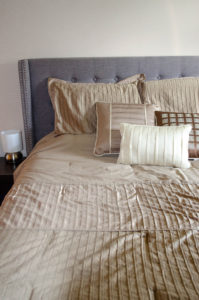 made bed with gold comforter