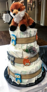 woodland themed diaper cake with fox stuffed animal topper